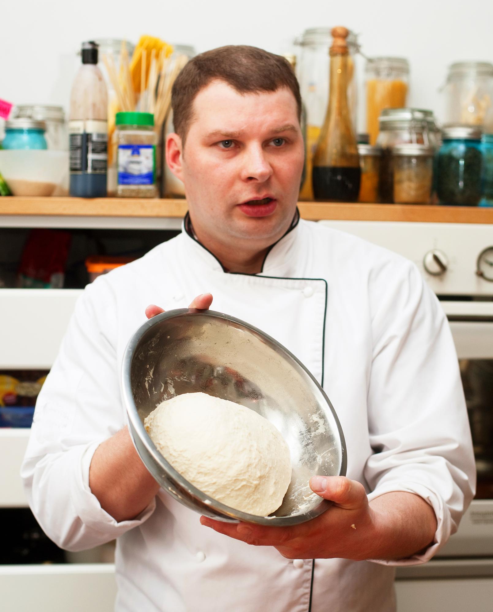 Instructor demonstrating dough handling to students